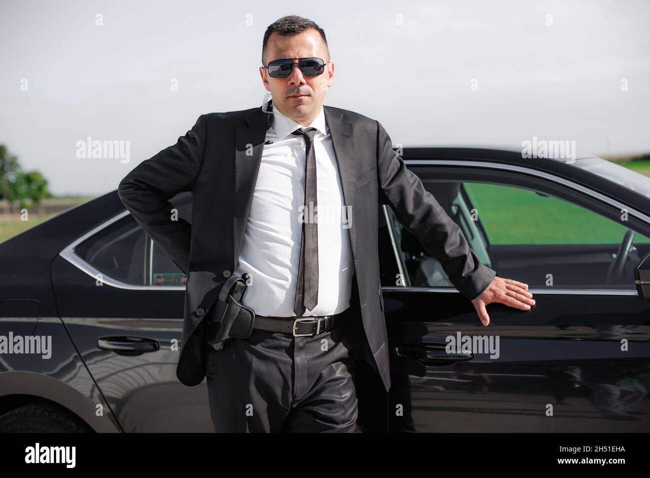 Professional male spy agent bodyguard with gun. Security police in