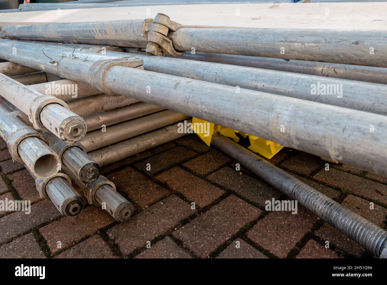 Pile of components of hired scaffolding or mobile platform work tower Stock Photo