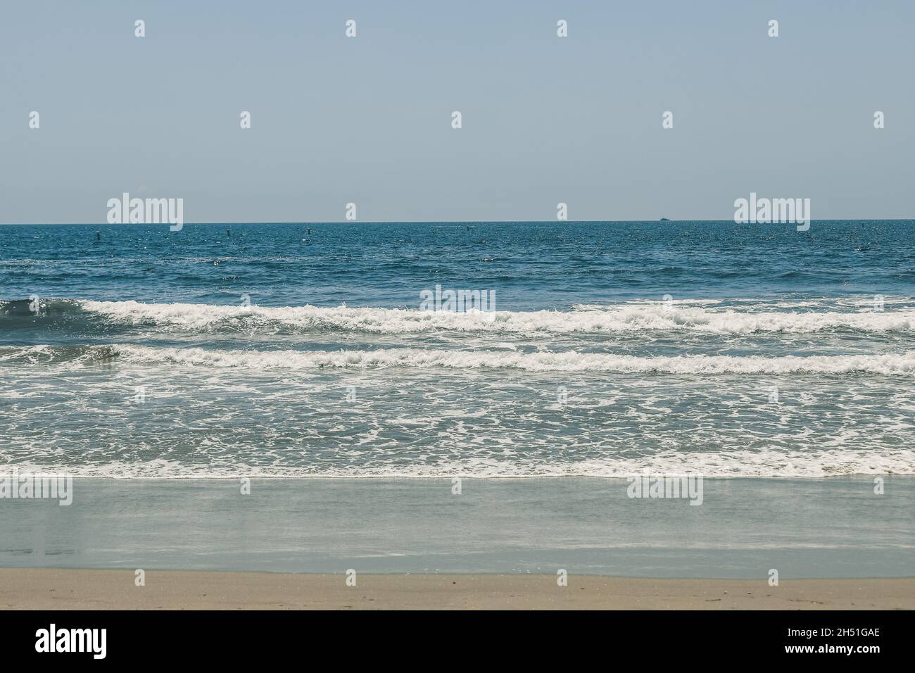 Beautiful view of a beach with splashing waves Stock Photo - Alamy