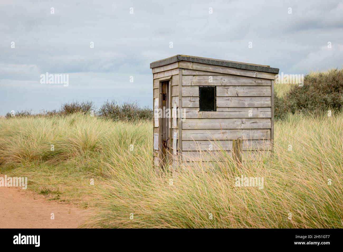 A wood hut for safety from high tides in a wild dune landscape on Spurn Point island Stock Photo