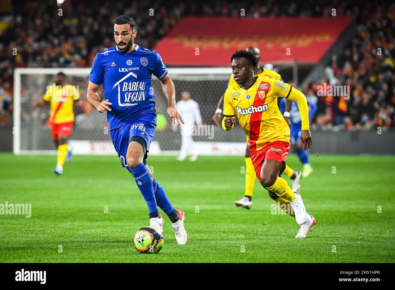 Lens, France. 05th Nov, 2021. Adil RAMI of ESTAC Troyes and Arnaud KALIMUENDO of Lens during the French championship Ligue 1 football match between RC Lens and ESTAC Troyes on November 5, 2021 at Bollaert-Delelis stadium in Lens, France - Photo: Matthieu Mirville/DPPI/LiveMedia Credit: Independent Photo Agency/Alamy Live News Stock Photo