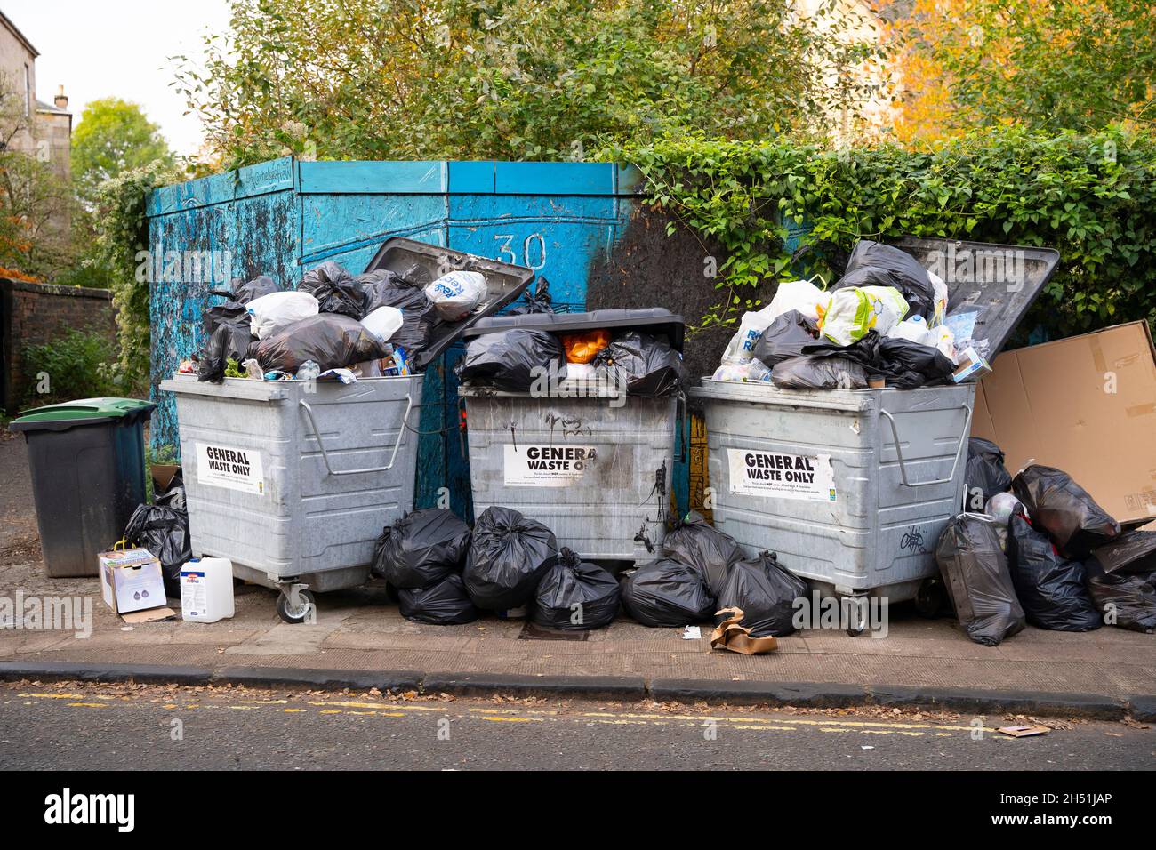 Glasgow, Scotland, UK. 5th November 2021. Rubbish piled beside refuse bins on street in Finnieston Glasgow. Refuse collectors in the city are currently on strike over pay and conditions.   Iain Masterton/Alamy Live News. Stock Photo