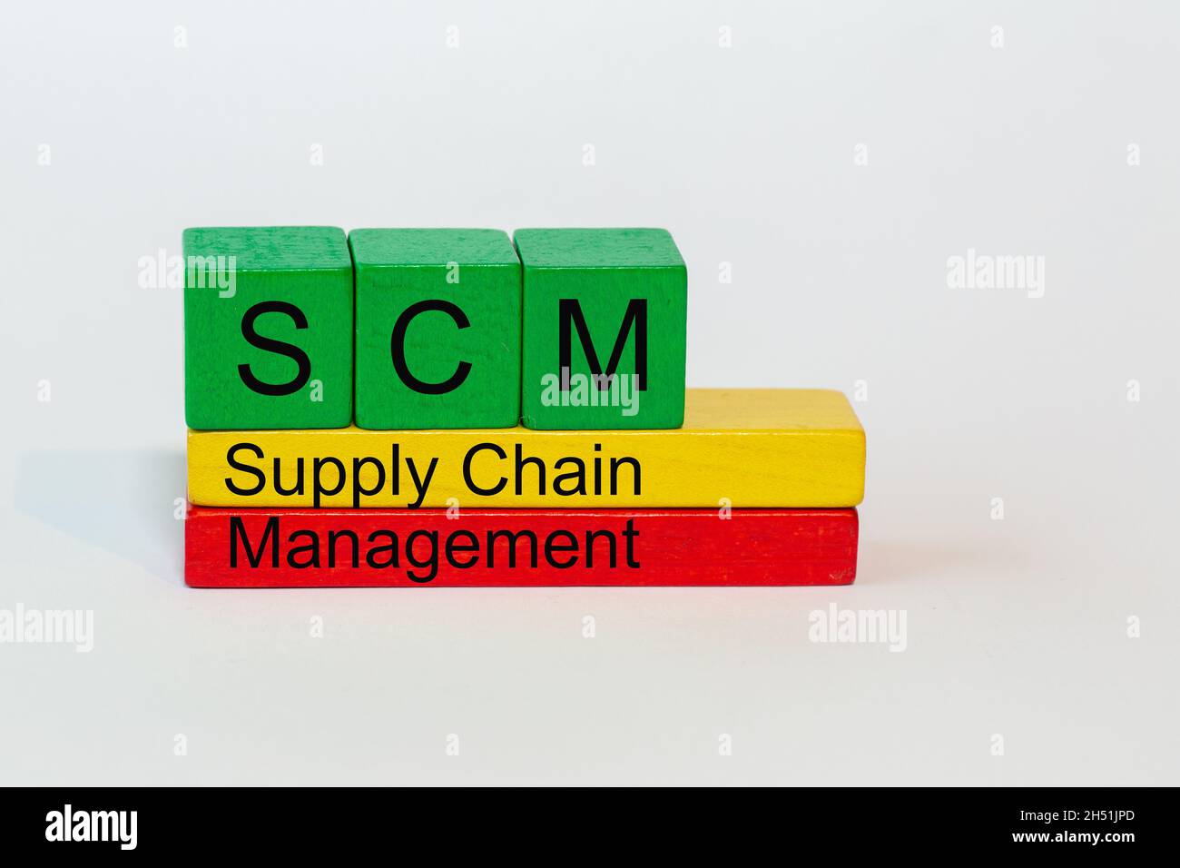 SCM is the abbreviation of Supply Chain Management and stands on colorful toy blocks isolated against a white background Stock Photo