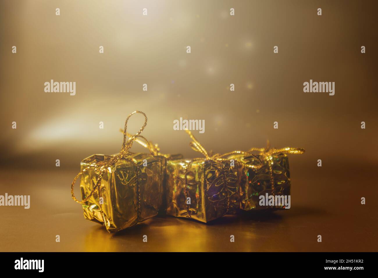 Christmas gold background with gifts in gold packaging. Stock Photo