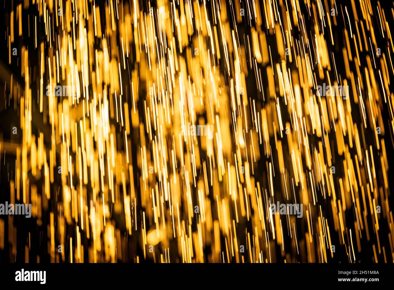 Abstract background of heavy rain shower with waterdrops in the golden