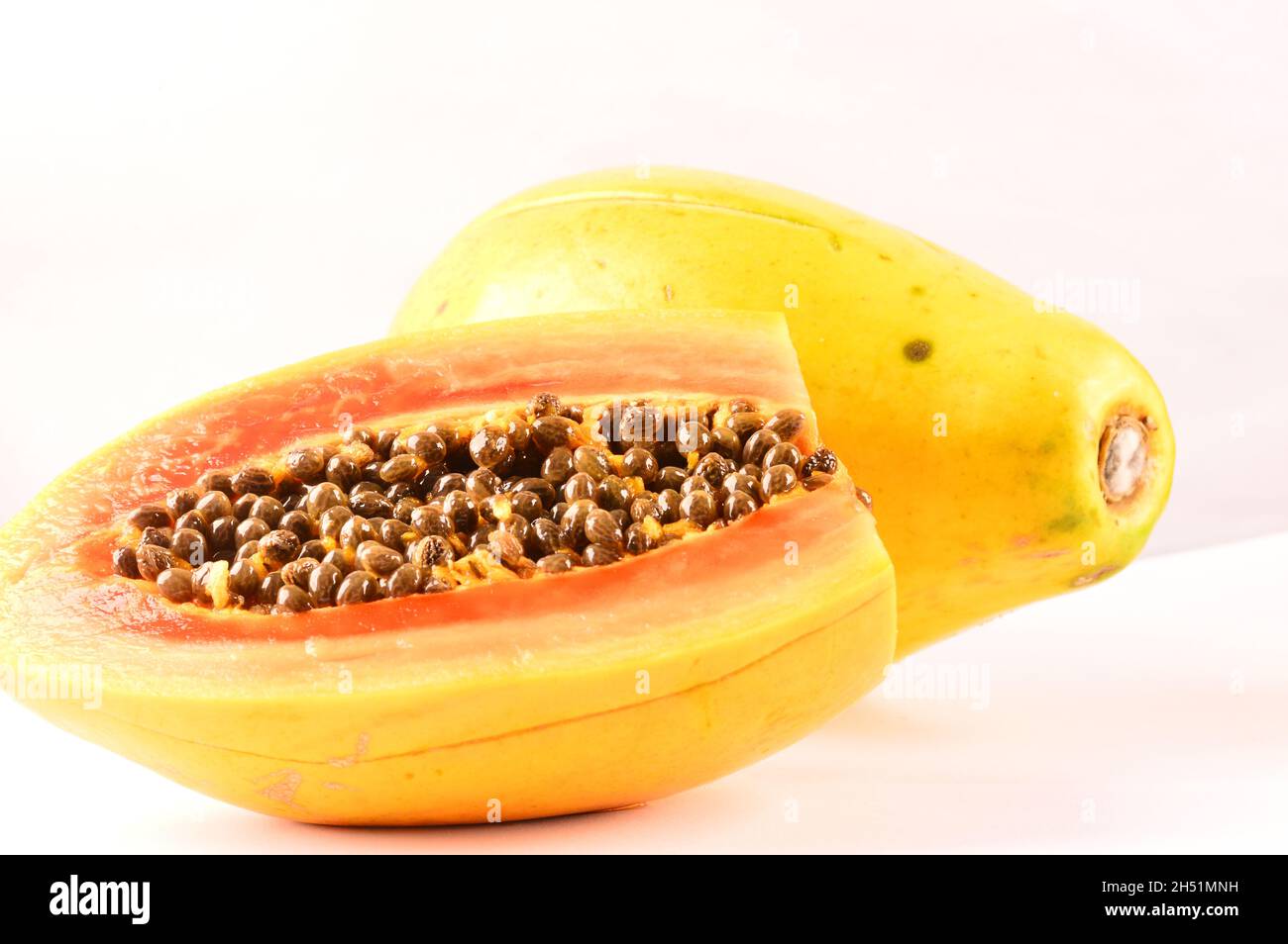 Papaya seeds on a sliced fruit on white background Stock Photo Alamy