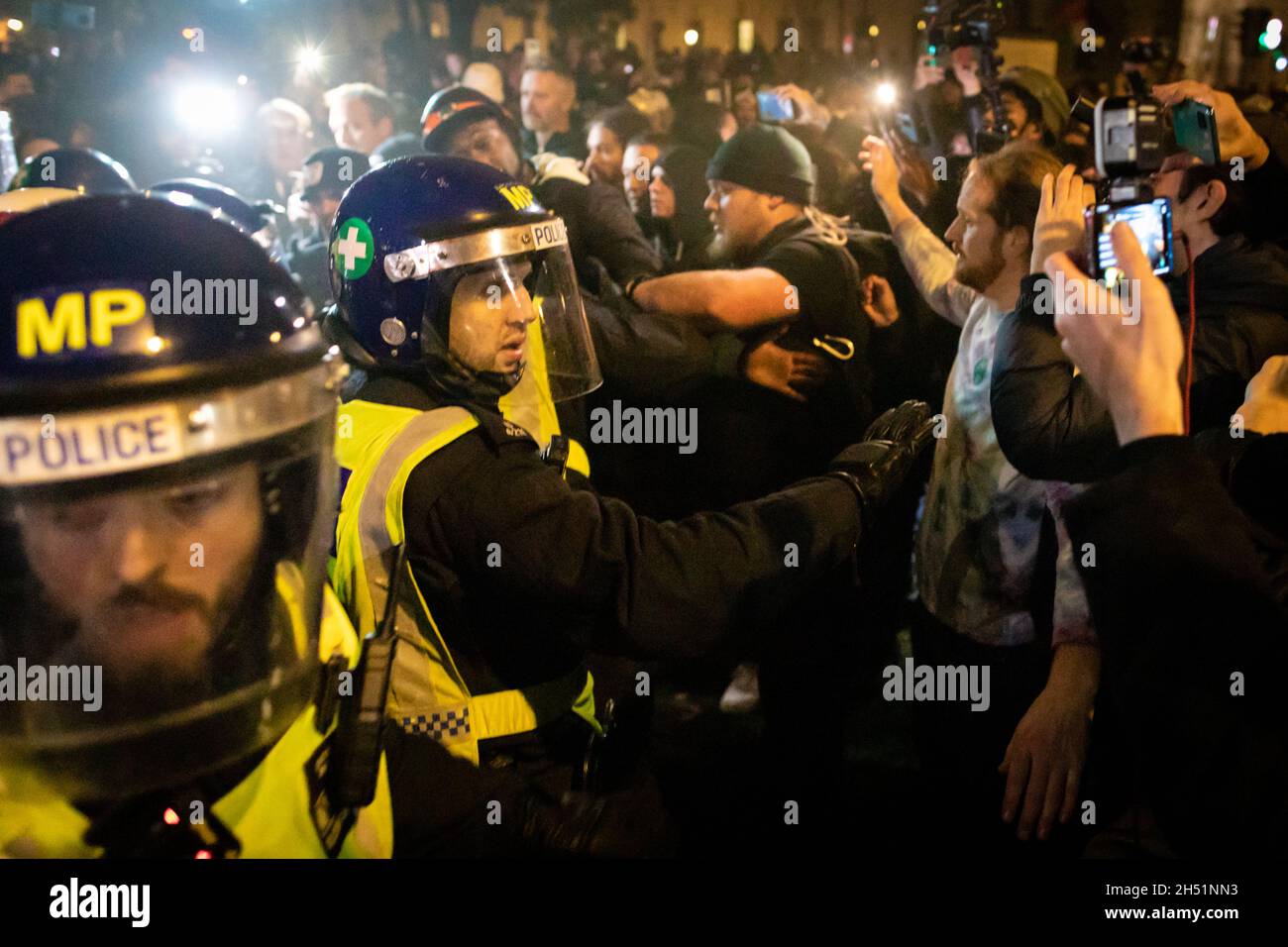 London, UK. 05th Nov, 2021. Police clash with protesters as they move in outside the Houses of Parliament during the annual Million Mask march through the city. The Anonymous movement stands in solidarity for a society which is marginalised by the political elite and associated corporations. Credit: Andy Barton/Alamy Live News Stock Photo