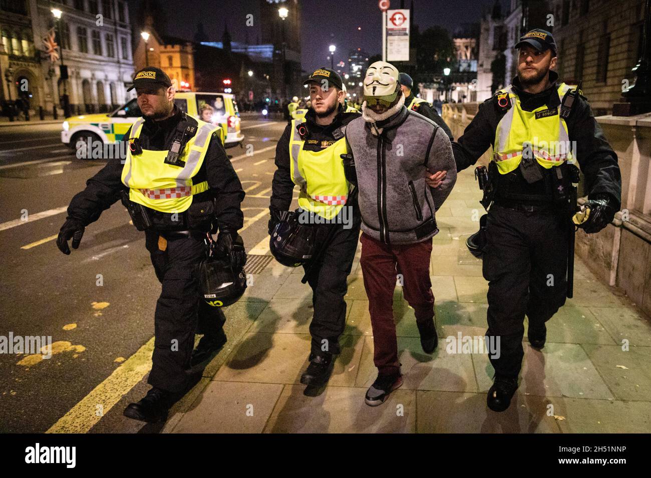 London, UK. 05th Nov, 2021. A protester is detained by police and led away during the annual Million Mask march through the city. The Anonymous movement stands in solidarity for a society which is marginalised by the political elite and associated corporations. Credit: Andy Barton/Alamy Live News Stock Photo