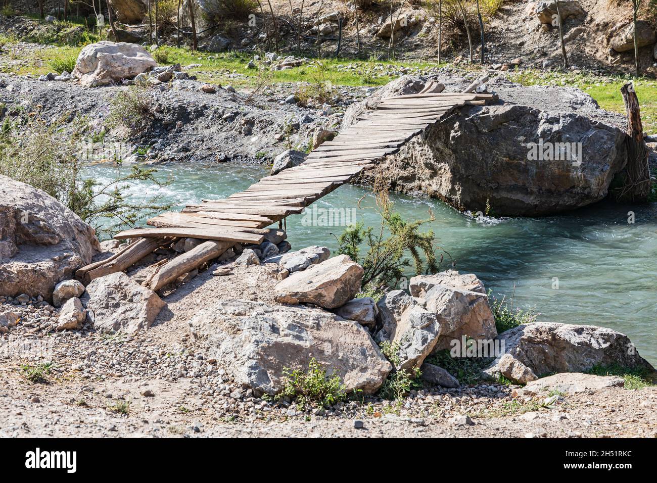 Mavzoley Rudaki, Sughd Province, Tajikistan. Simple wooden bridge across the Urech River. Stock Photo