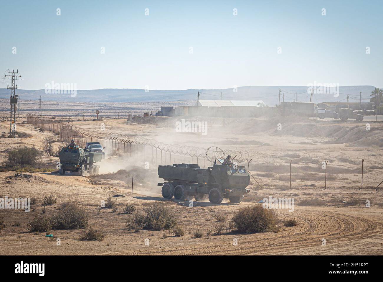 211104-M-VL720-1082 BISLAH, Israel (Nov. 4, 2021) Marines assigned to Bravo Battery, Battalion Landing Team 1/1, 11th Marine Expeditionary Unit, convoy High Mobility Artillery Rocket Systems during an Israeli interoperability exercise at Bislah Training Center, Israel, Nov. 4. This is the United States’ and Israel’s first bilateral training since Israel joined the U.S. Central Command area of responsibility and is a robust demonstration of both nations’ commitment to stability in the region. (U.S. Marine Corps photo by 1st Lt. Austin Gallegos/Released) Stock Photo