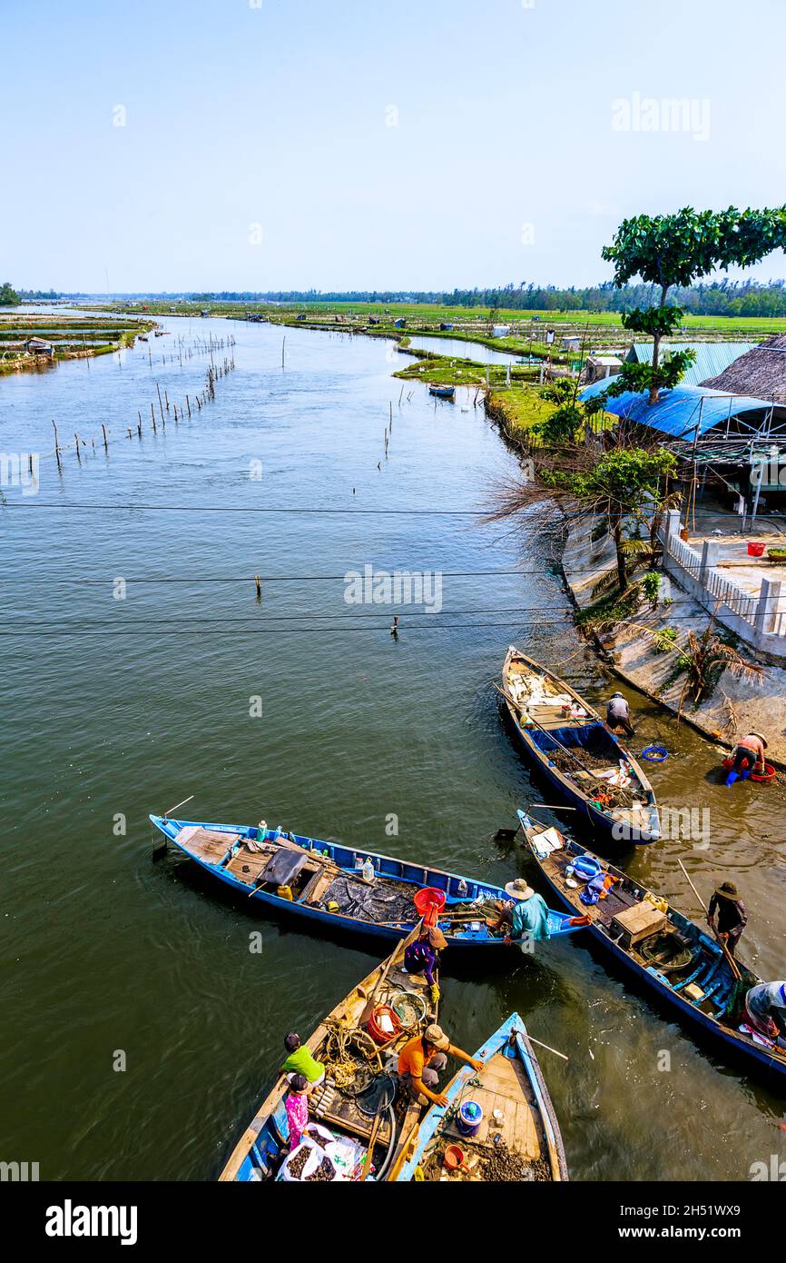 Cargo of rice loaded on the small boats on the Truong Giang river by Tam Thanh. Stock Photo