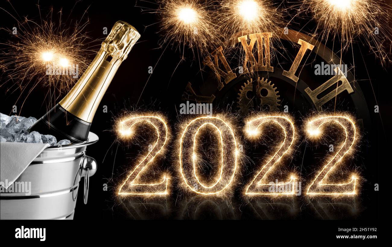 2022 sparkler number with clock and champagne bottle in cooler on black. happy new year eve dark background Stock Photo