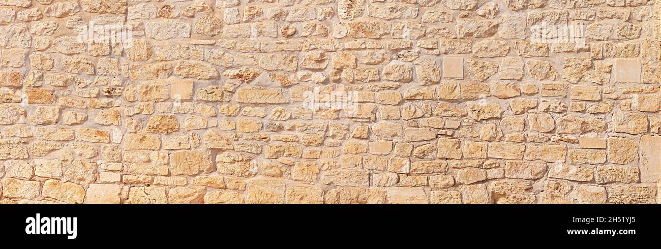 natural wide panorama wall design pattern background with rustic rough warm sand stone texture Stock Photo