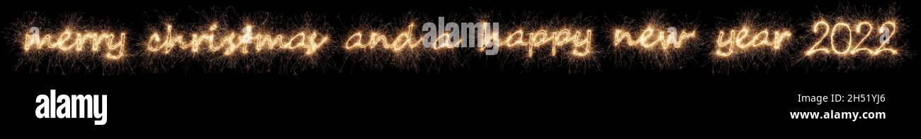 merry christmas and a happy new year 2022 greeting. golden bright modern sparkler number and letter isolated on black. silvester eve celebration backg Stock Photo