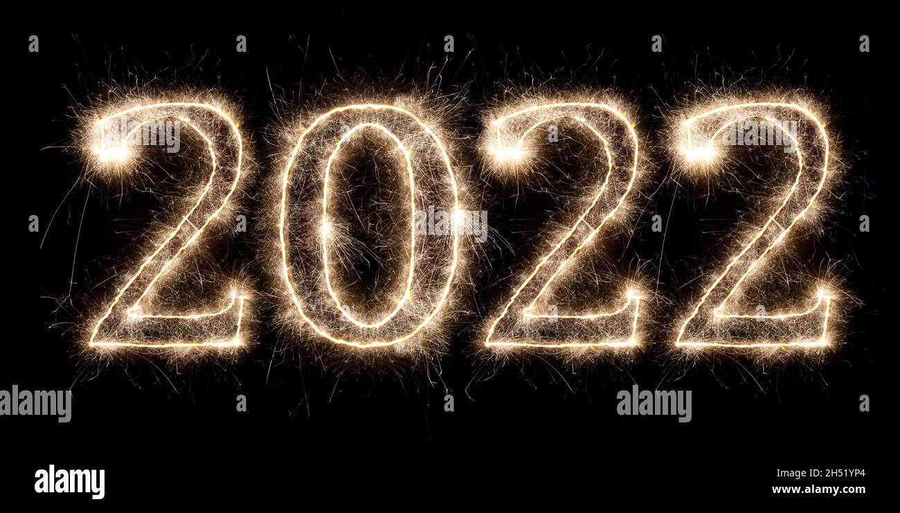 golden bright sparkler number 2022 isolated on black. happy new year eve celebration background Stock Photo
