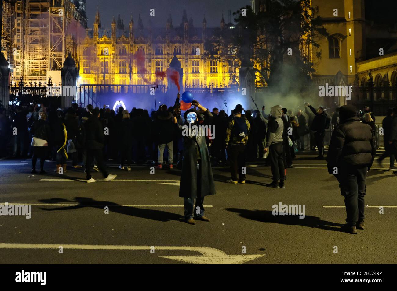 London, UK, 5th Nov, 2021. Protesters gathered for the Million Mask March in central London where numerous fireworks and smoke flares were set off around Parliament Square. Numbers were boosted for the anti-establishment demonstration by anti-vaccine passport protesters joining in this year. Credit: Eleventh Hour Photography/Alamy Live News Stock Photo