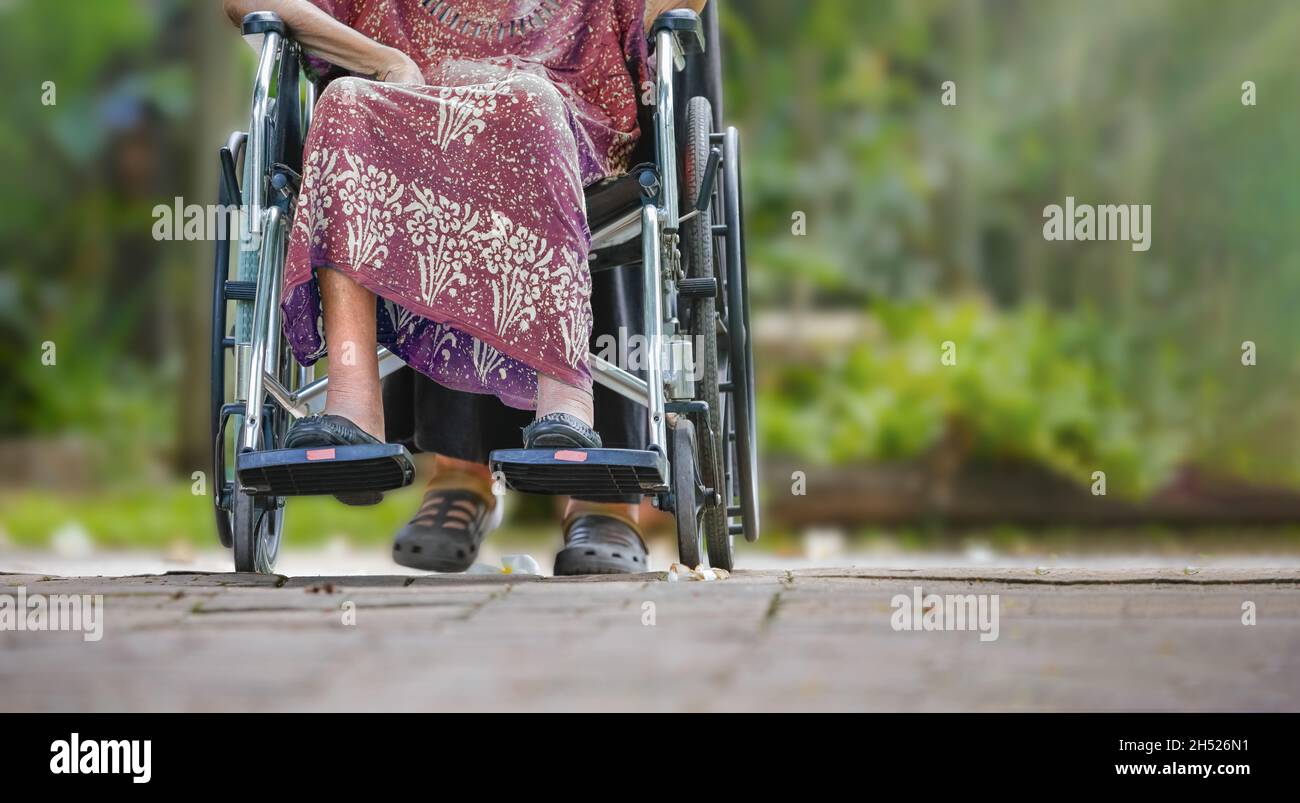 Elderly woman on wheelchair at home with daughter take care Stock Photo