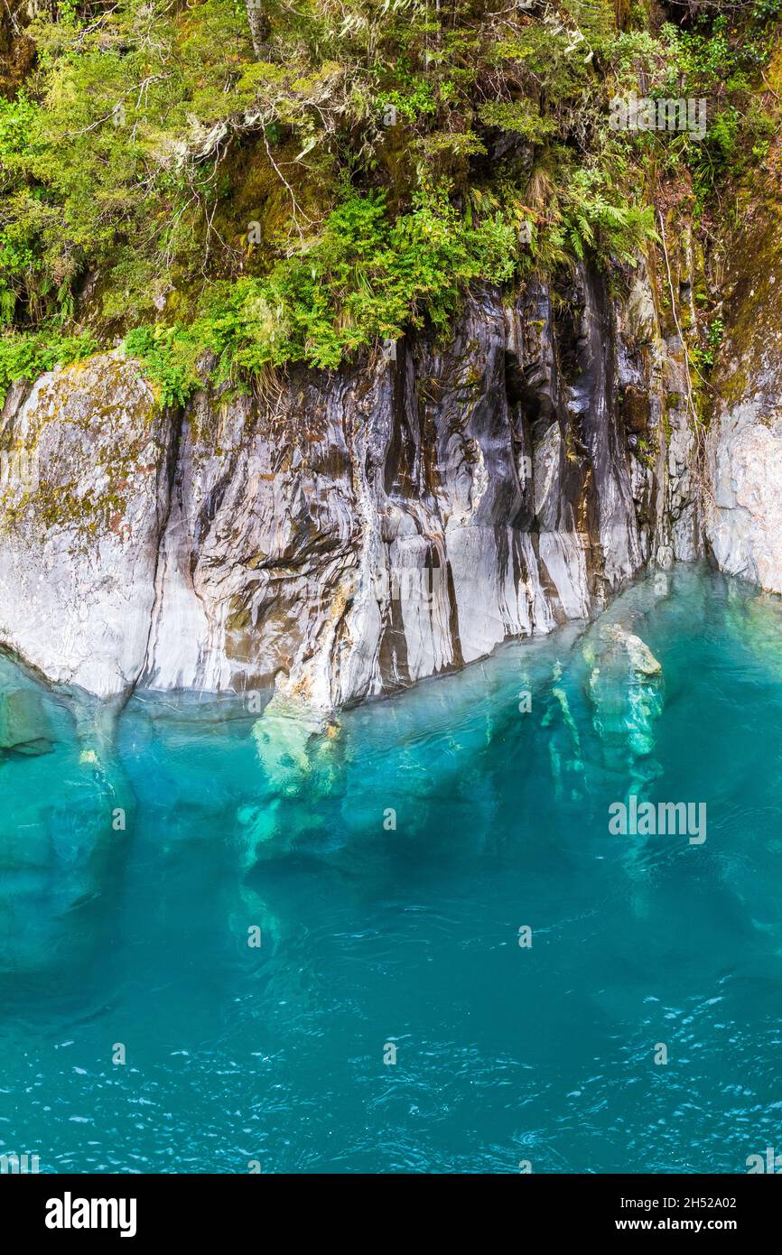 Steep cliffs and blue water. South Island, New Zealand Stock Photo - Alamy