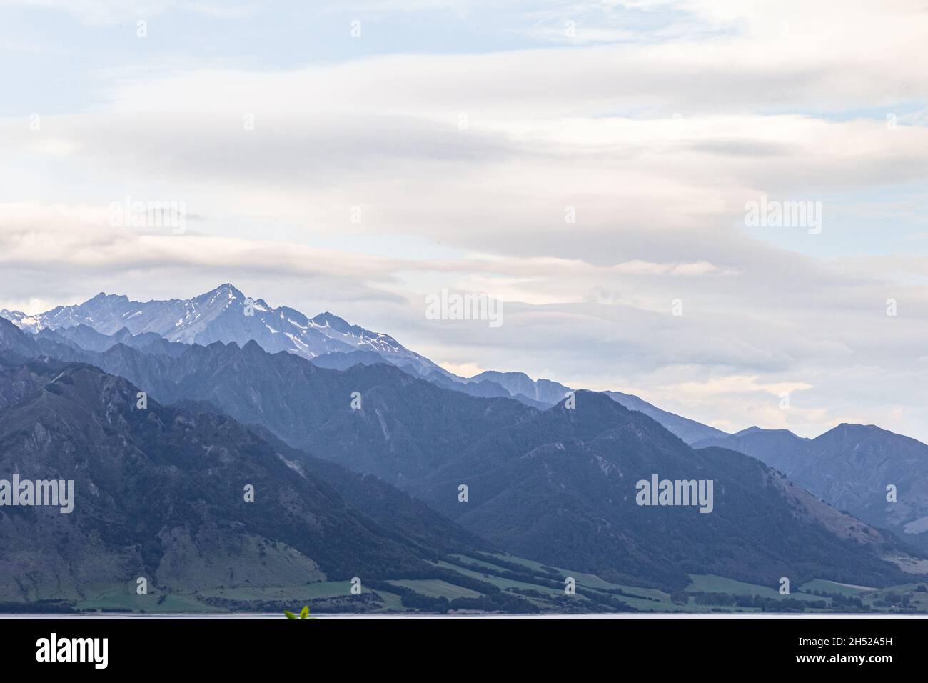 Sheer cliffs by the Hawea lake. New Zealand, South Island Stock Photo ...