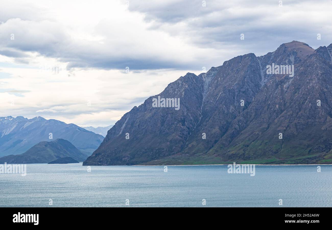 Steep cliffs by Hawea lake. South Island, New Zealand Stock Photo - Alamy