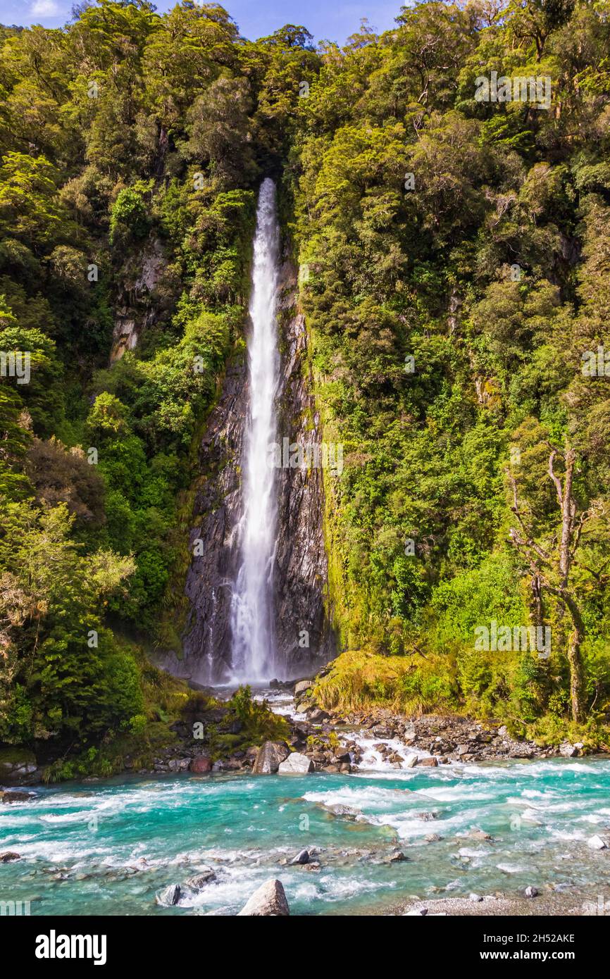 Landscapes of New Zealand. Small high waterfall among the greenery. South Island Stock Photo