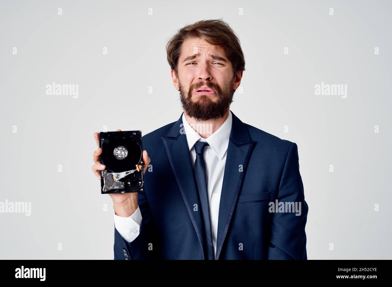 emotional business man with hard drive on computer technology Stock Photo