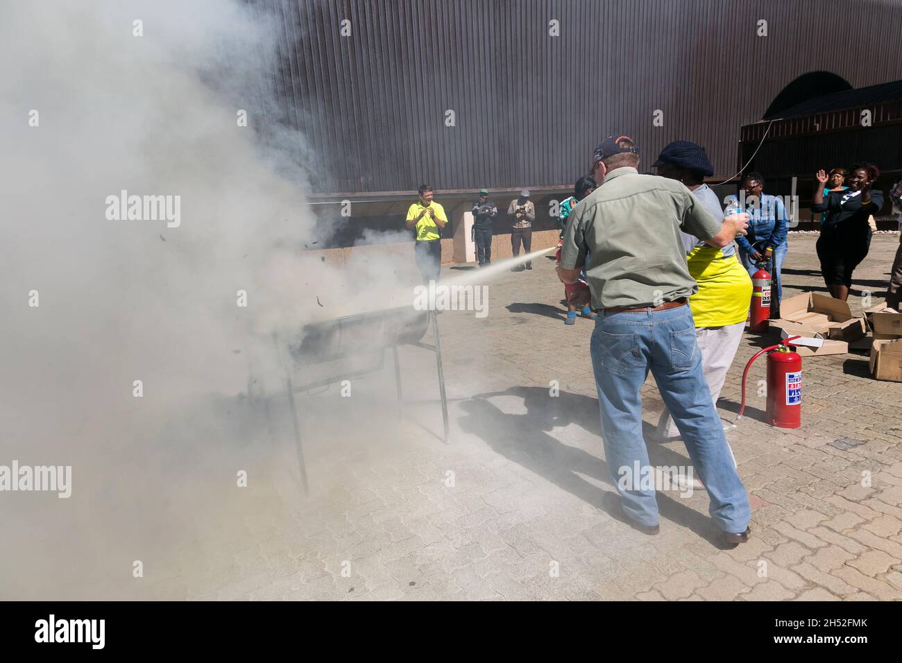 JOHANNESBURG, SOUTH AFRICA - Aug 12, 2021: The process of fire hazard training with a powder-based extinguisher in Johannesburg, South Africa Stock Photo
