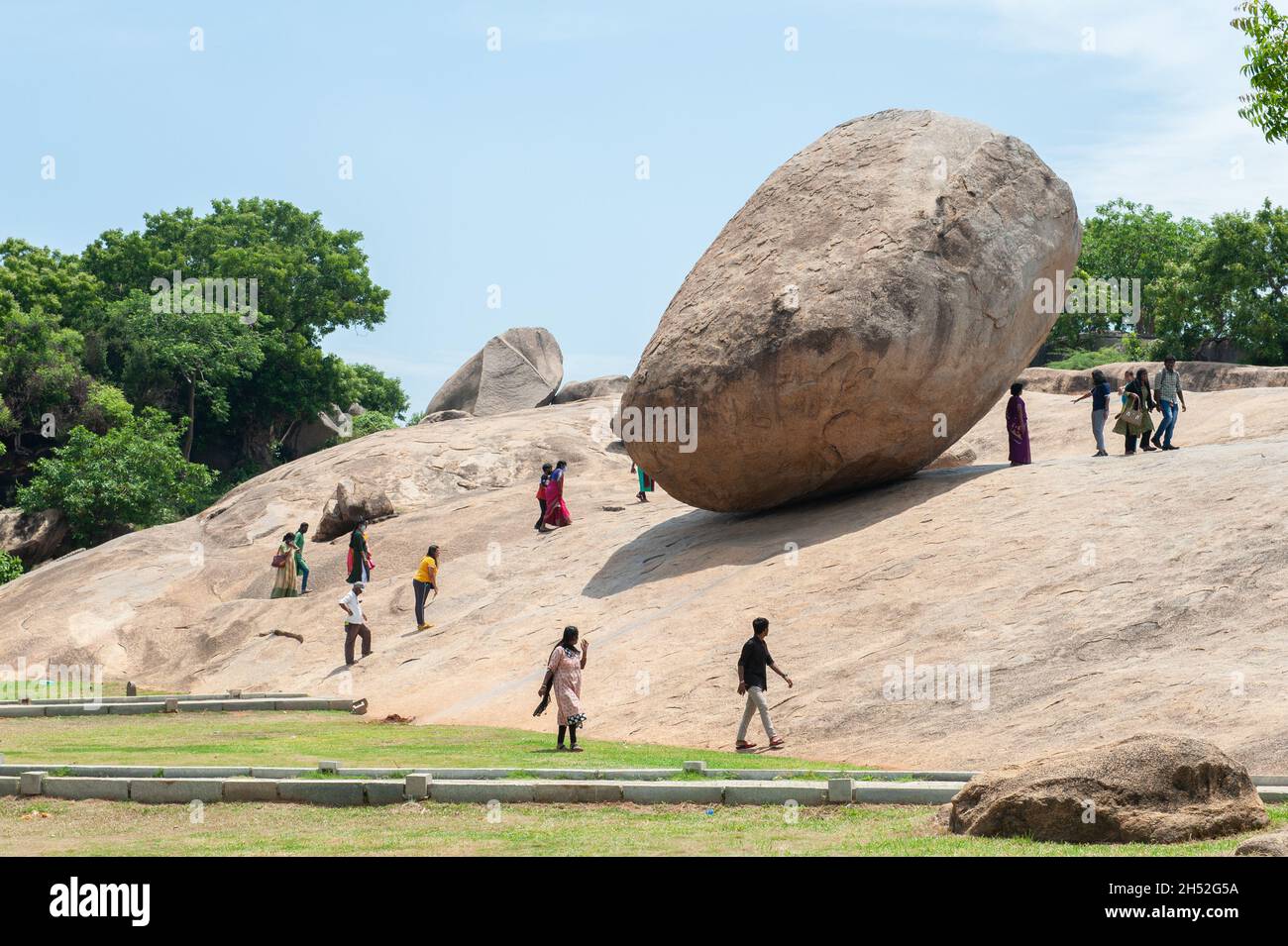 Mamallapuram, India - August 2021: Krishna’s Butter Ball is a massive boulder balanced on a small hill near the Ganesha Ratha stone temple Stock Photo