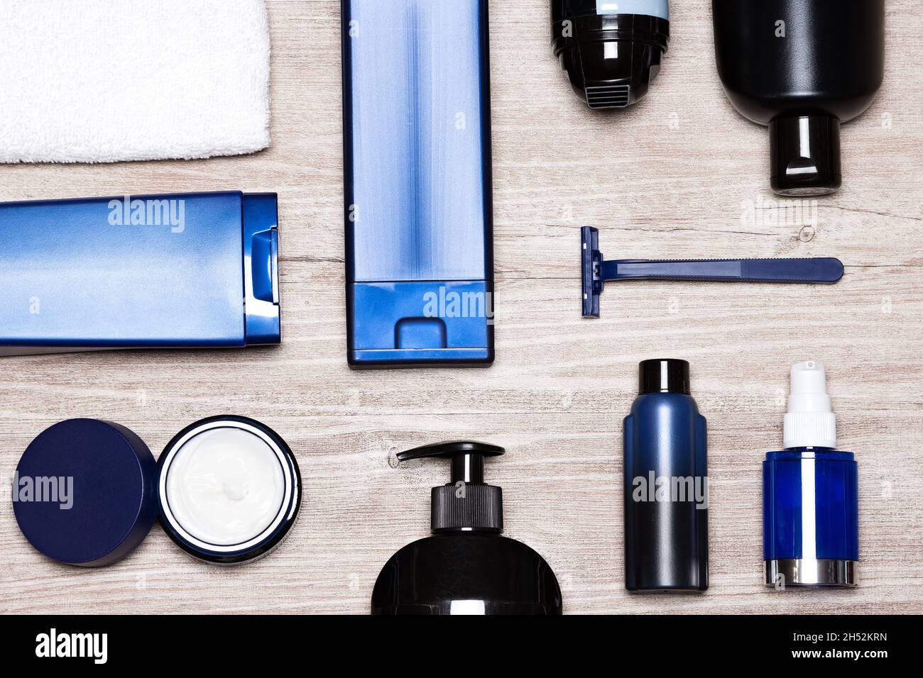 Men cosmetics. Essential male grooming products on shabby wooden surface, flat lay Stock Photo