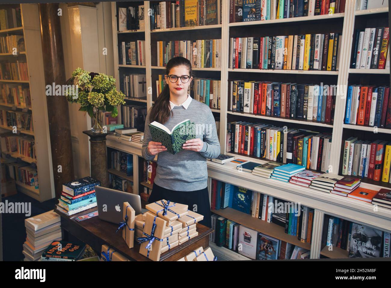 GREAT BRITAN / London / Bookstores / Beautiful woman reading a book in a bookstore. Stock Photo