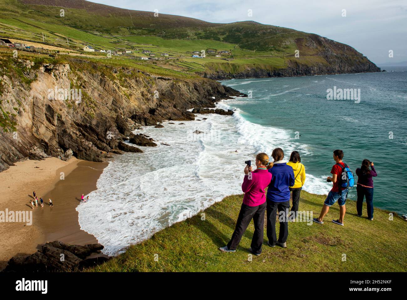 Tourists photographing Coumeenoole beach, Slea Head drive, Dingle Peninsula, County Kerry, Ireland Stock Photo