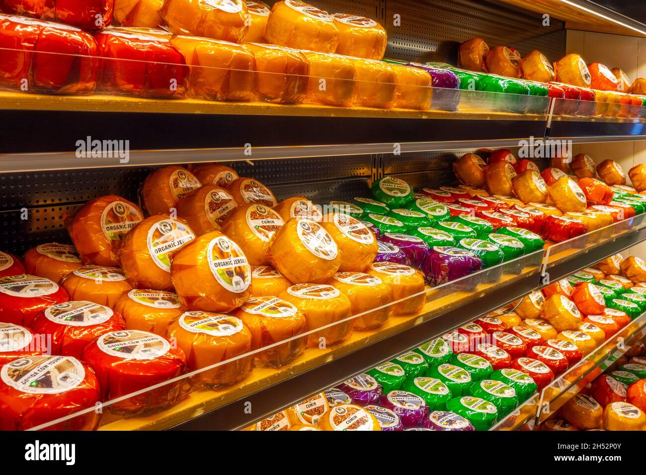 Netherlands. Dutch cheese shop. A rack with many small heads of cheese of different varieties Stock Photo