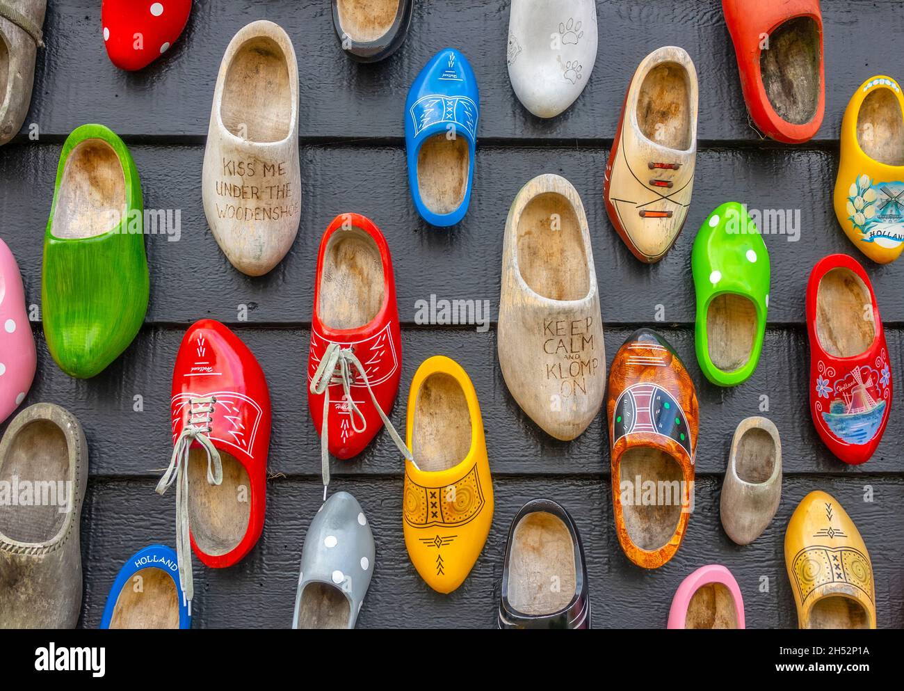 Netherlands. Zaanse Schans. Many different clogs hang on the wall of a wooden house Stock Photo