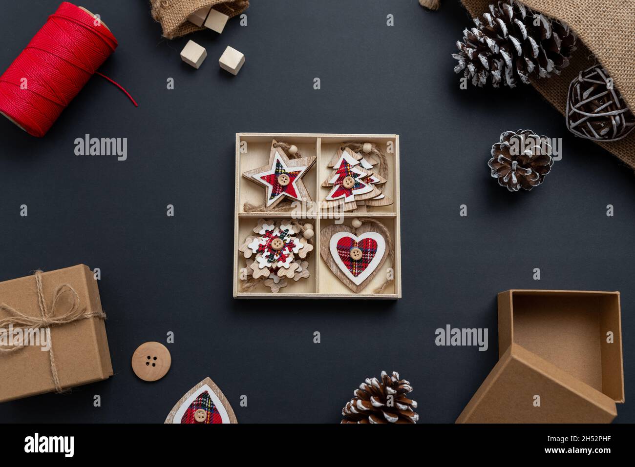 Unpacking Christmas decorations. Christmas composition with small wooden decorations for the Christmas tree. Top view, flat lay Stock Photo