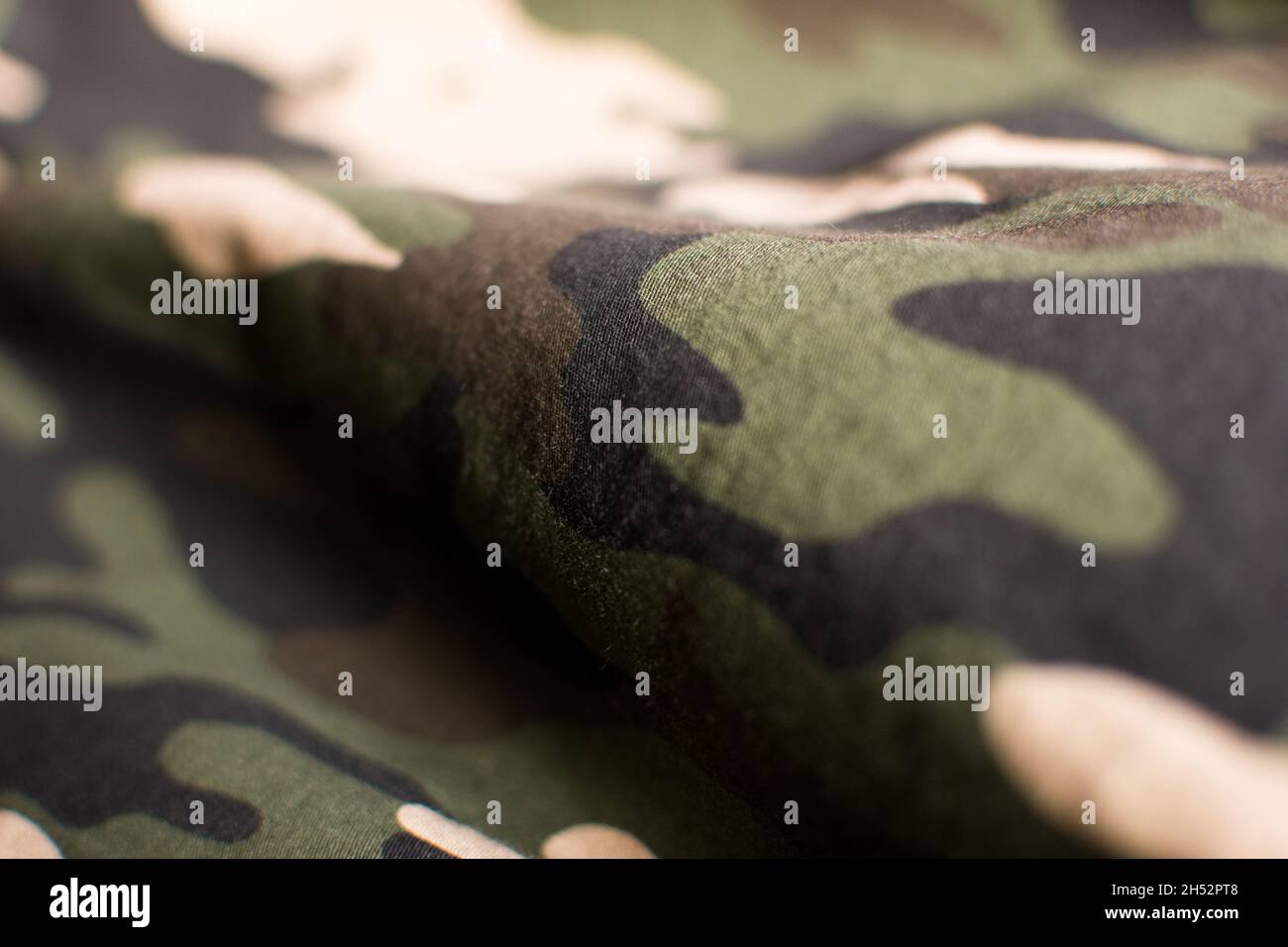 Military green, black, beige and brown uniform, close up Stock Photo