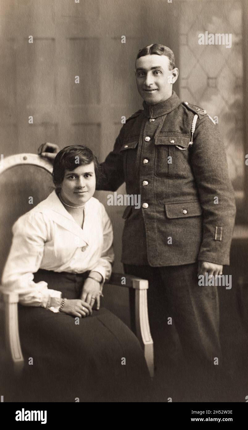 A First World War era portrait of a soldier and his wife. The man is a Gunner in a Royal Garrison Artillery unit of the Territorial Force. The two stripes on his lower left arm indicate he was wounded twice on active service. Stock Photo