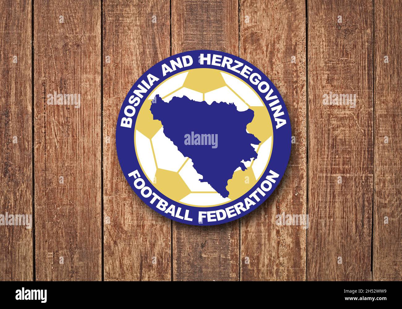 The coat of arms of the Football Association of Bosnia and Herzegovina on a wooden background Stock Photo