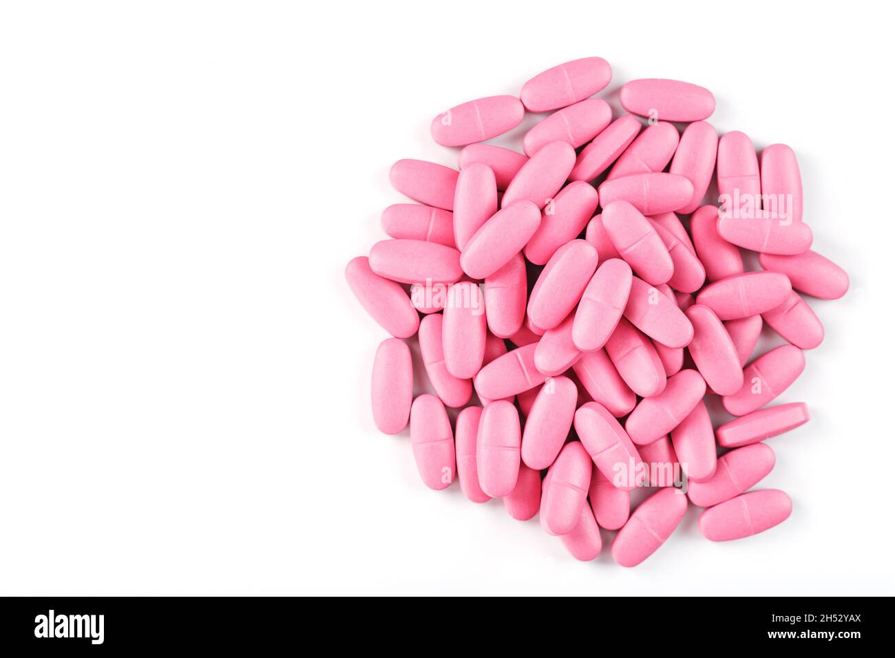 Pink vitamin pills for women on a white background. Multivitamins for women's health, isolate, free space Stock Photo