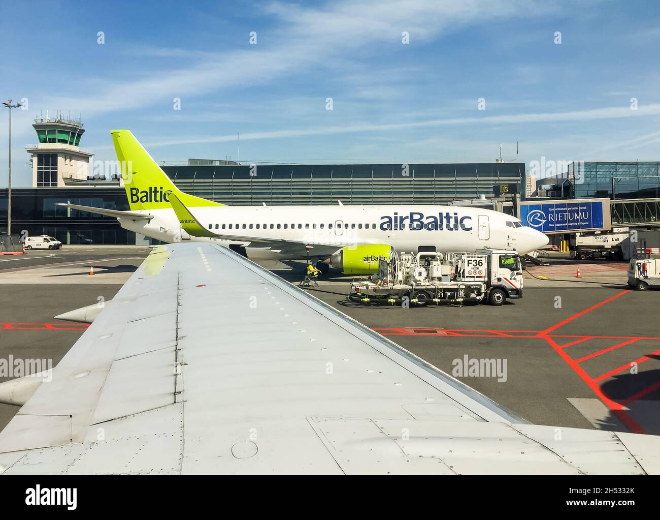 Riga, Latvia - May 5, 2018: AirBaltic Aircraft preparation for departure in the Riga International Airport. Stock Photo