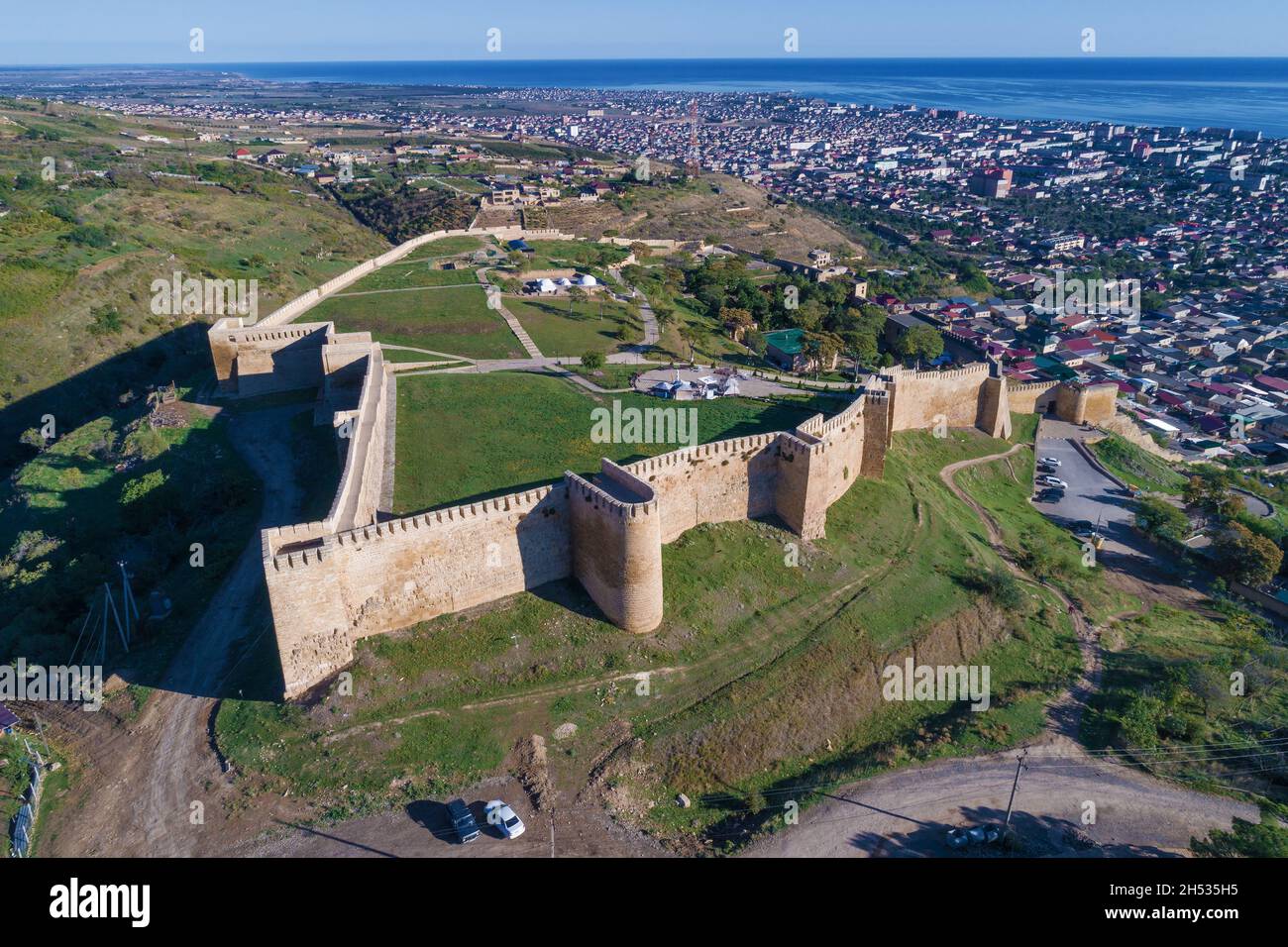 Ancient fortress Naryn-Kala against the backdrop of Derbent on a sunny September day (aerial photography). Republic of Dagestan, Russian Federation Stock Photo