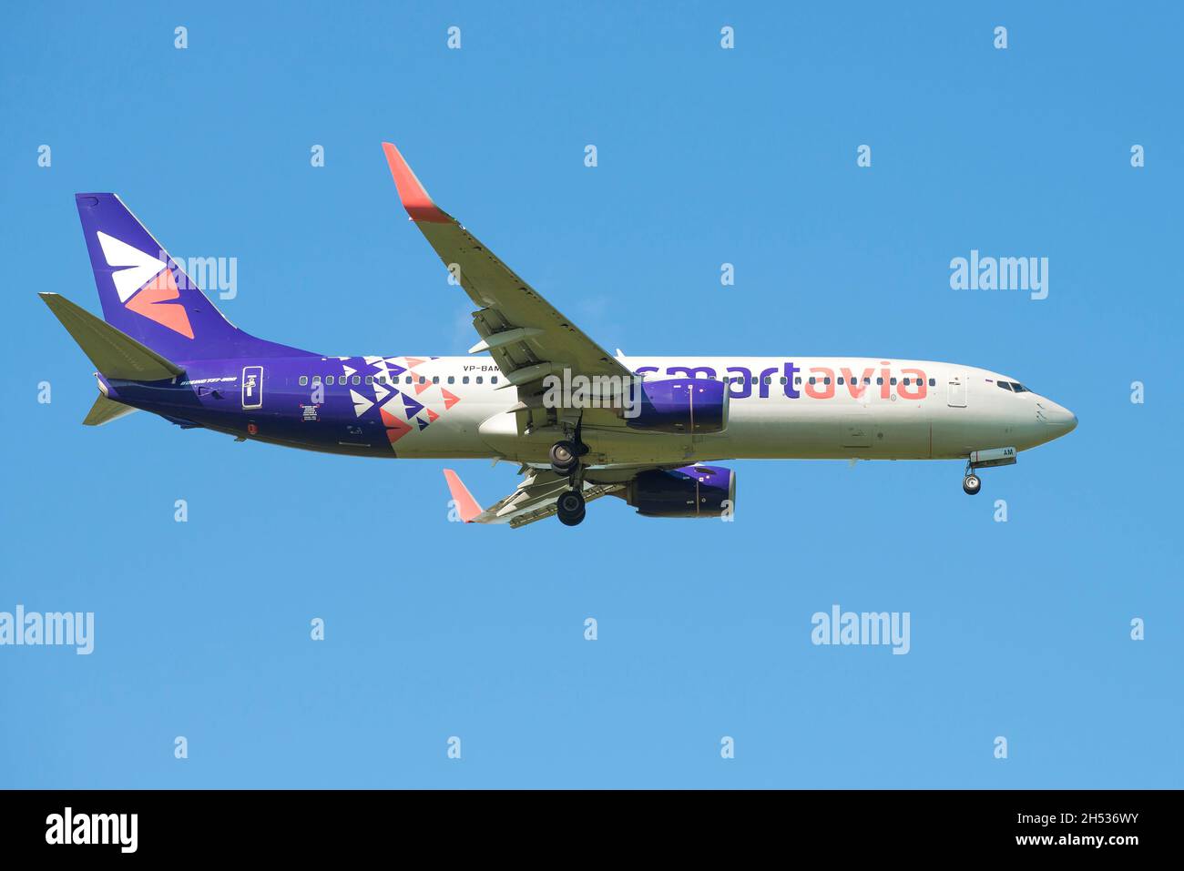 SAINT PETERSBURG, RUSSIA - MAY 29, 2021:  Boeing 737-800 (VP-BAV) of Smartavia Airlines comes in for landing in a blue cloudless sky Stock Photo