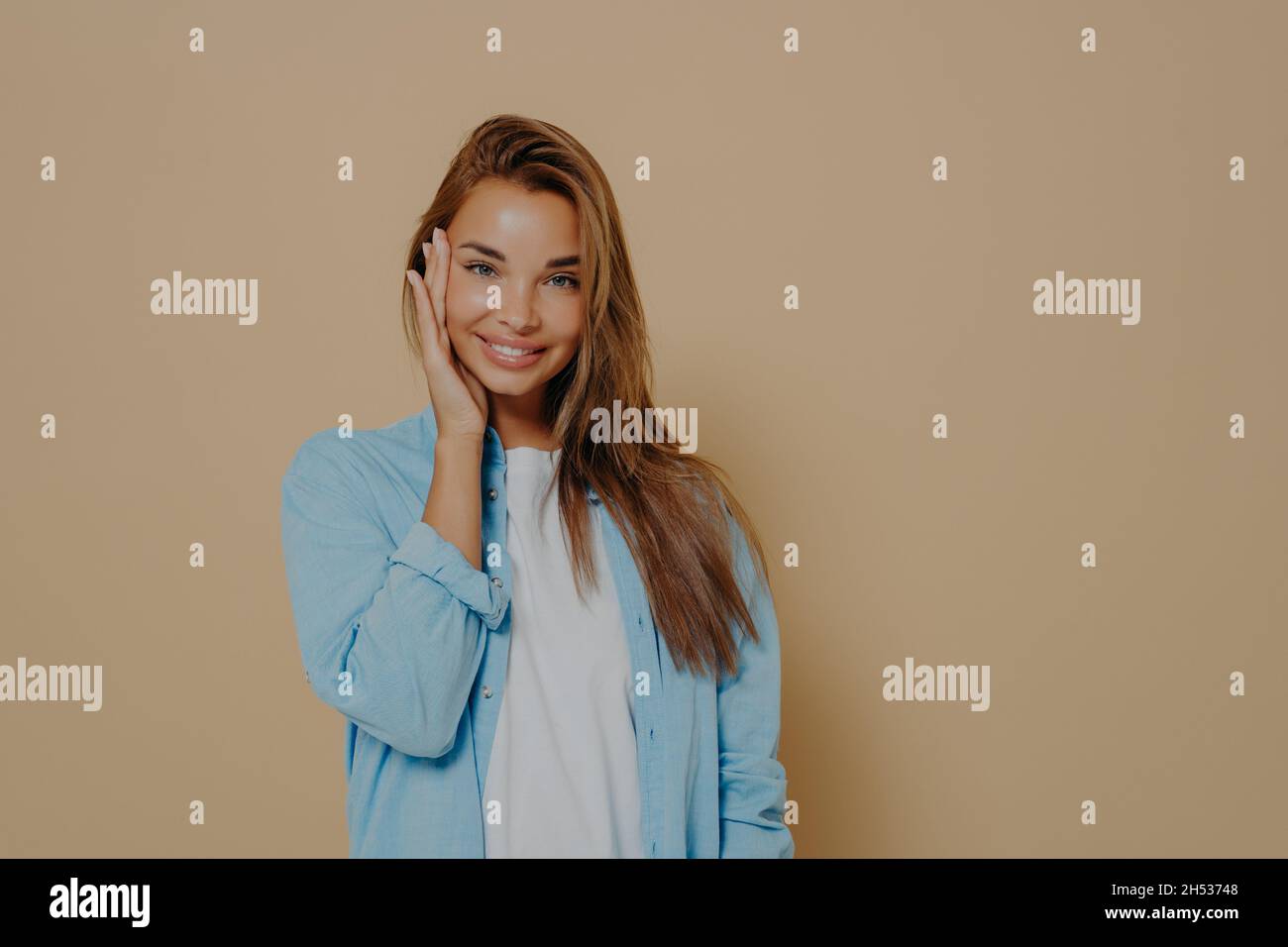 Young beautiful smiling caucasian female model posing in studio Stock Photo