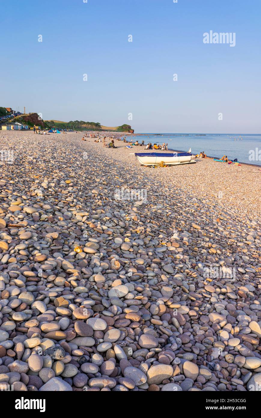 Dusk and Upturned boats on the Pebble beach at Budleigh Salterton beach Devon England UK GB Europe Stock Photo
