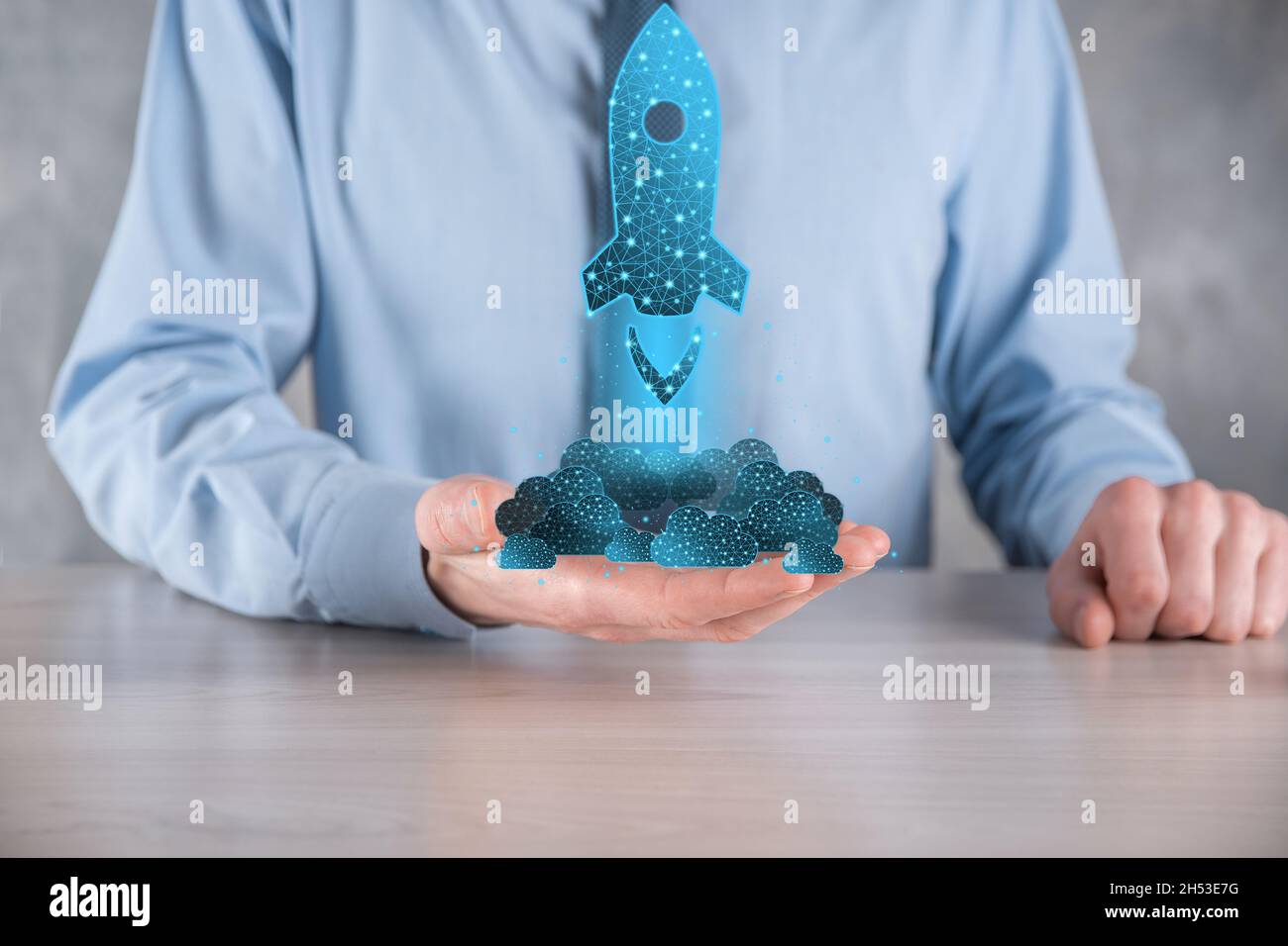 Startup business concept, Businessman holding in hand icon rocket is ...