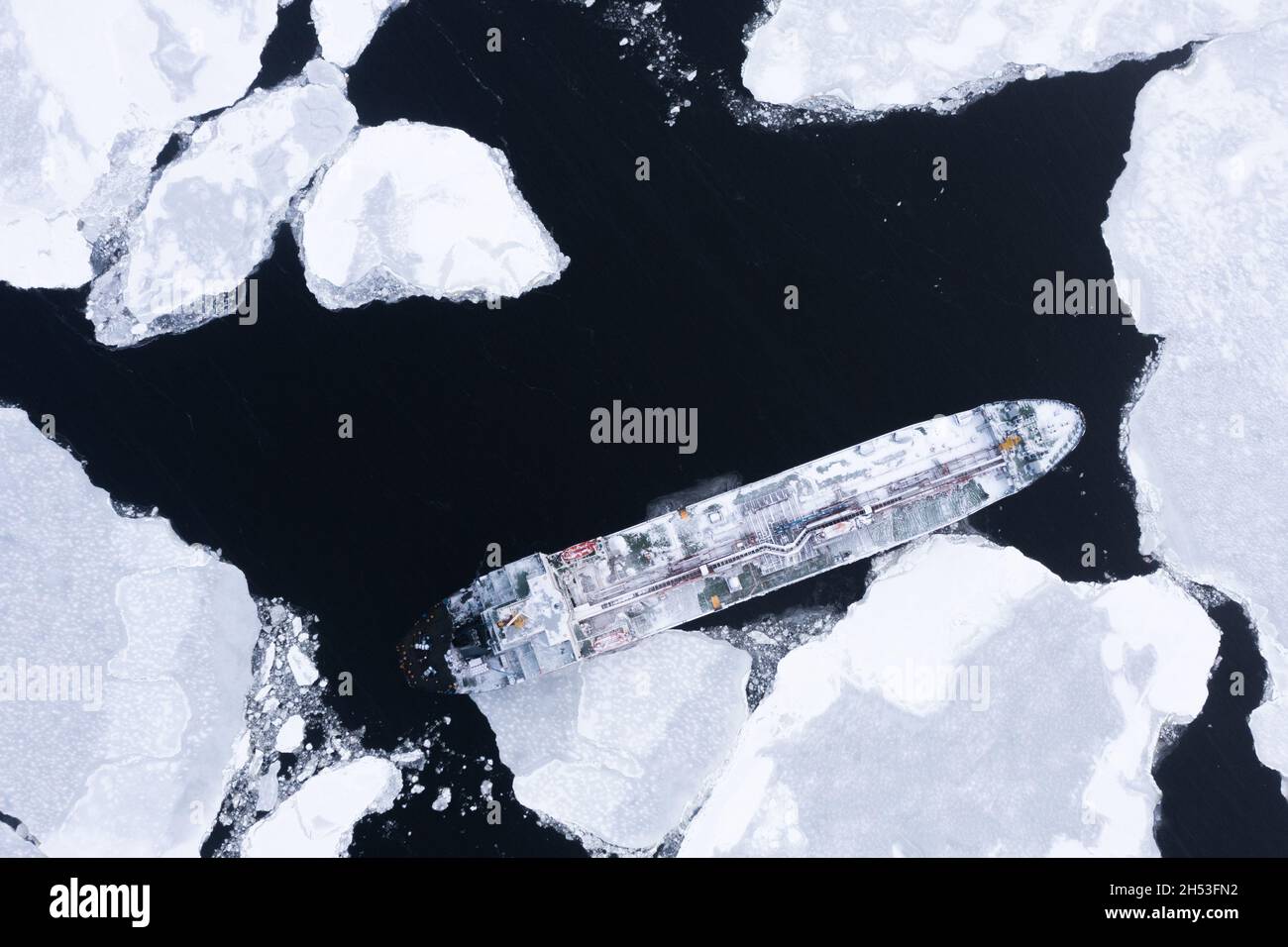 The ship is in the sea among the ice. Stock Photo