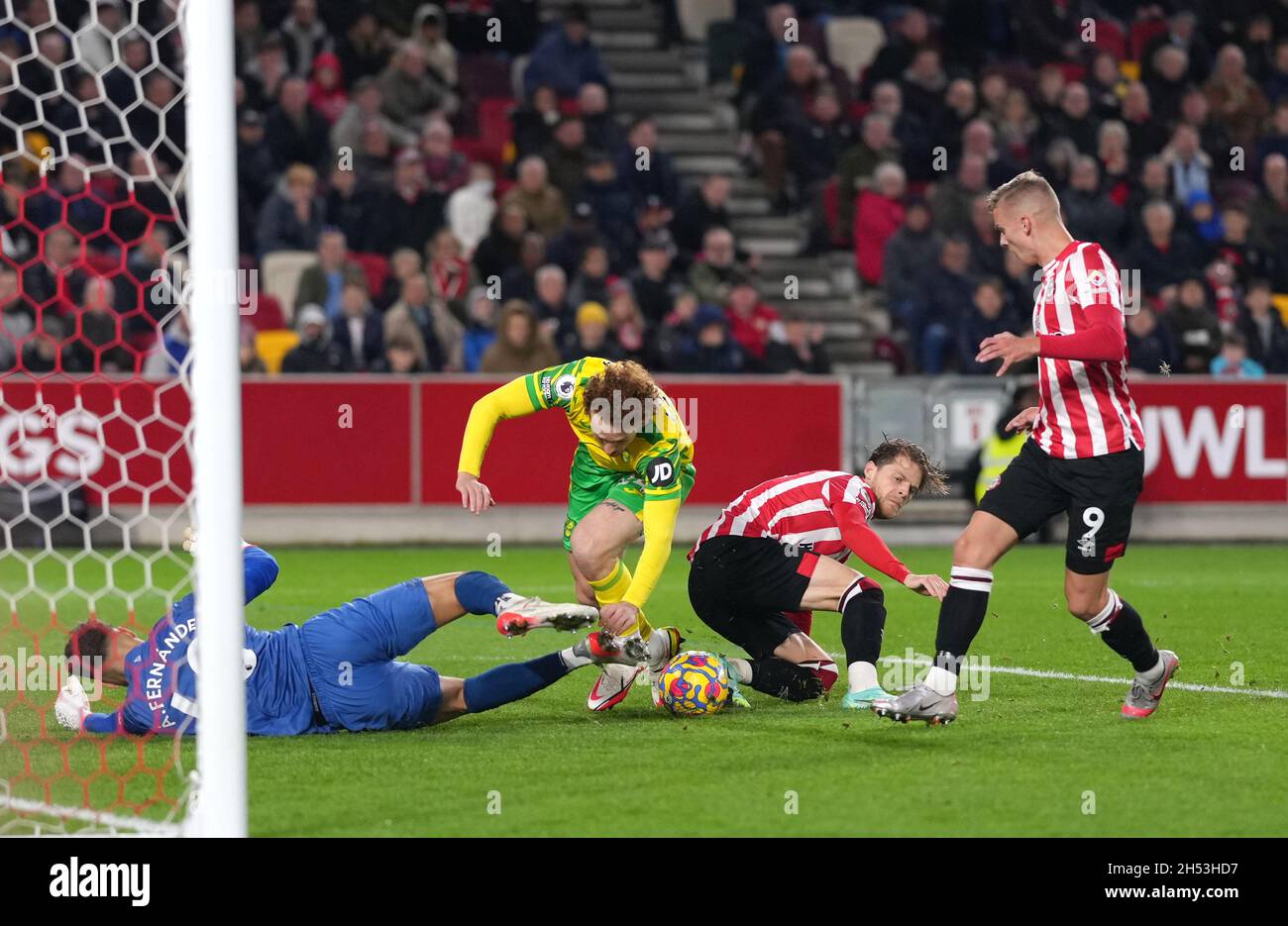 Norwich City's Josh Sargent tackled in the penalty area by Brentford goalkeeper Alvaro Fernandez during the Premier League match at Brentford Community Stadium, London. Picture date: Saturday November 6, 2021. Stock Photo