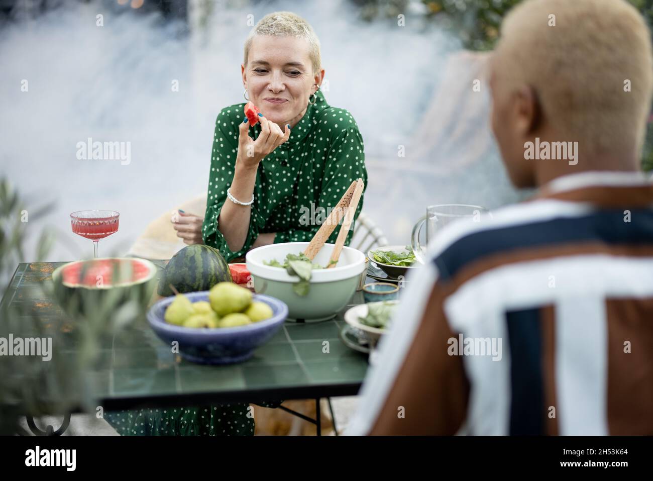 Multiracial couple having dinner at their backyard Stock Photo