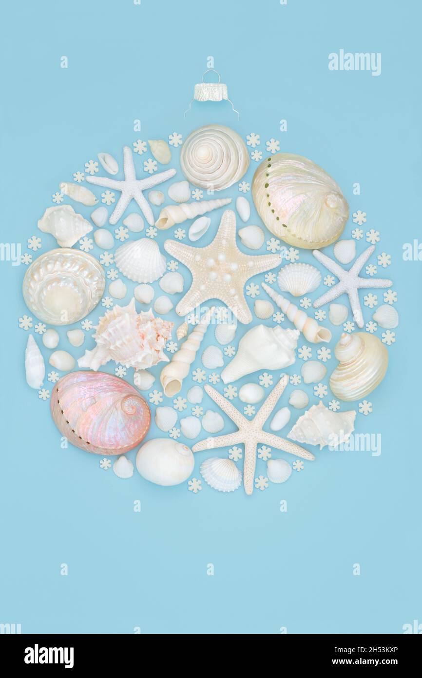 Abstract seashell and snowflake round Christmas tree bauble shape on blue background. Alternative concept for the Xmas southern hemisphere holiday. Stock Photo