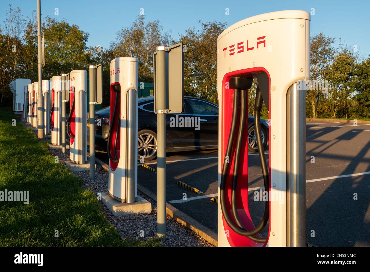 Tesla Supercharger station for charging electric cars vehicles at Telford  Motorway Services, Shropshire, England, UK Stock Photo - Alamy