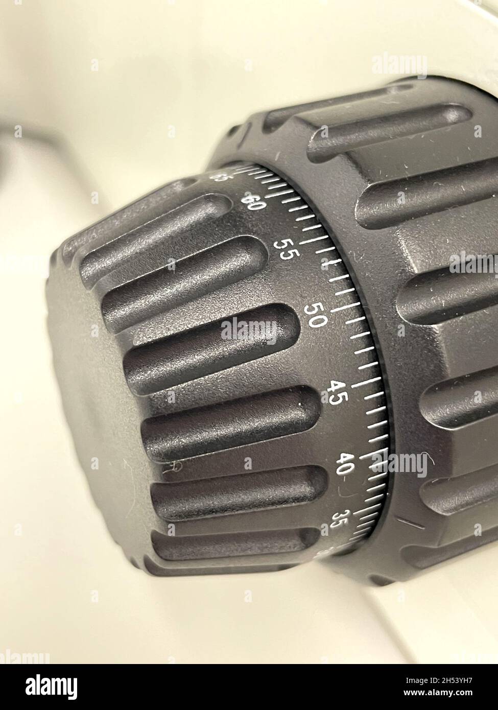 Closeup shot of the fine and coarse adjustment knobs of a microscope in the laboratory Stock